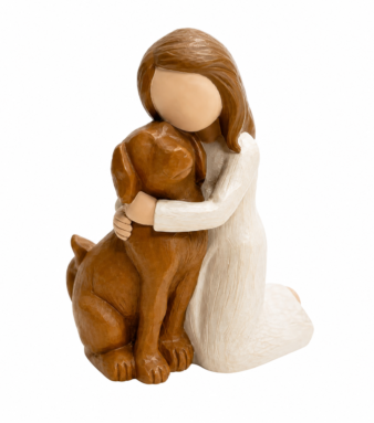 Woman hugging brown dog statue on mantelpiece beside candle and dog photo — dog home décor
