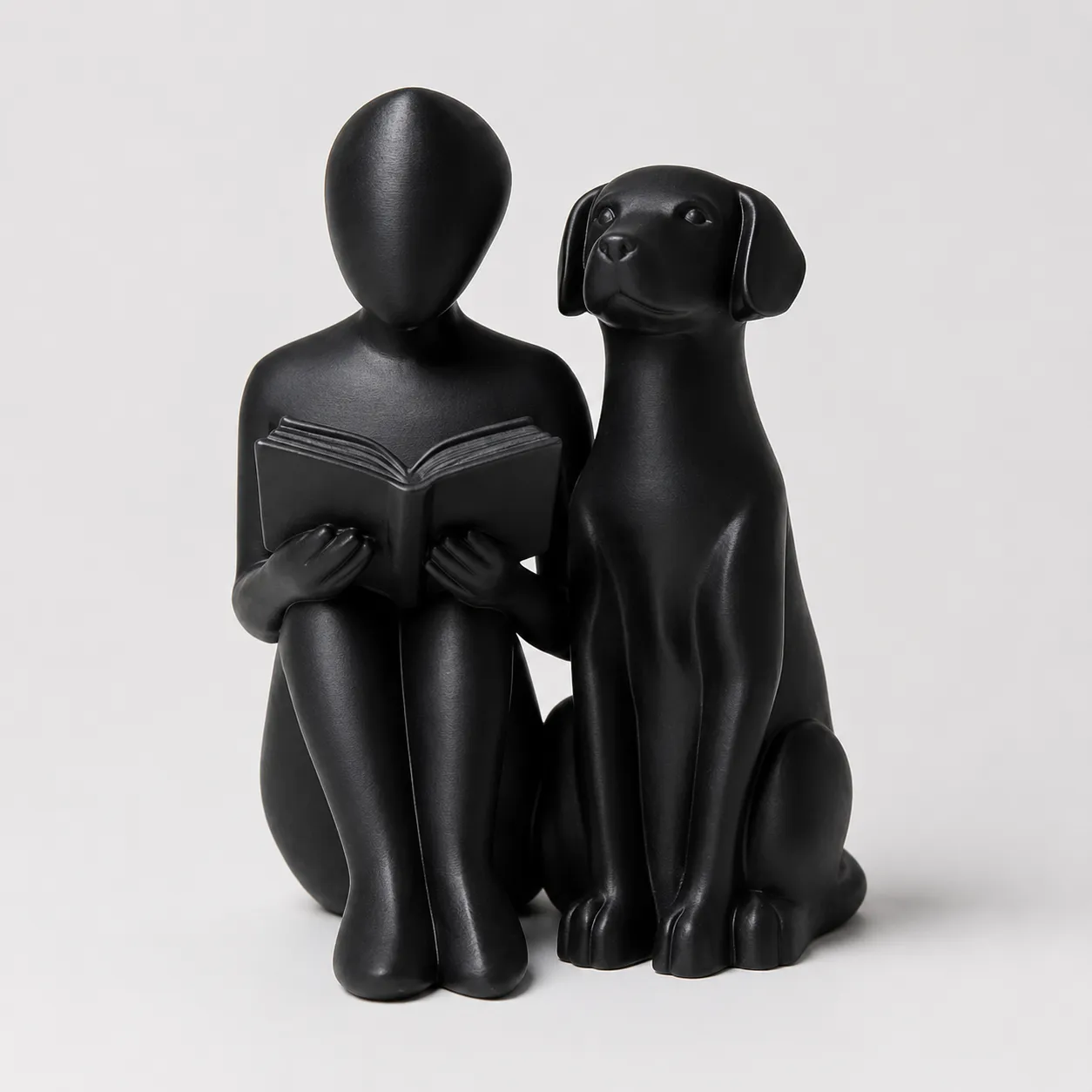 Abstract reading person dog statue in matte black — minimalist book lover dog gift